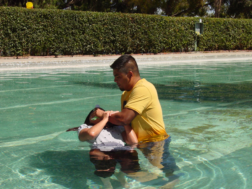 Tania being baptized